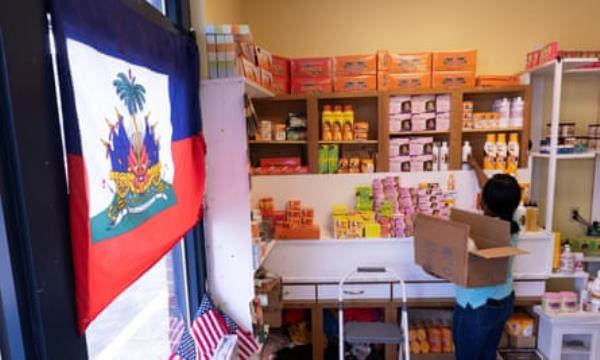 Philomene Philostin, a naturalized US citizen of Haitian origin, shelves merchandise in her store in Springfield, Ohio, on September 13, 2024.