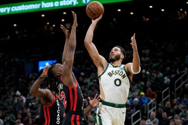 Jayson Tatum shooting over a Chicago Bulls player.