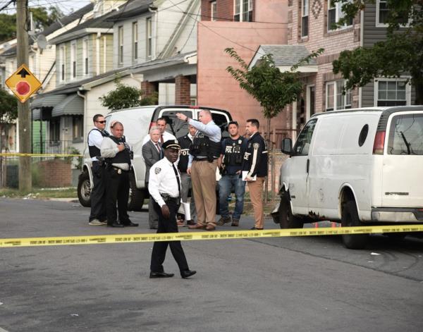 Police in front of police tape at the scene