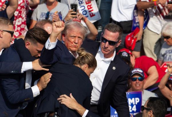 Republican candidate Donald Trump is seen with blood on his face surrounded by secret service agents as he is taken off the stage at a campaign event at Butler Farm Show Inc. in Butler, Pennsylvania, July 13, 2024.